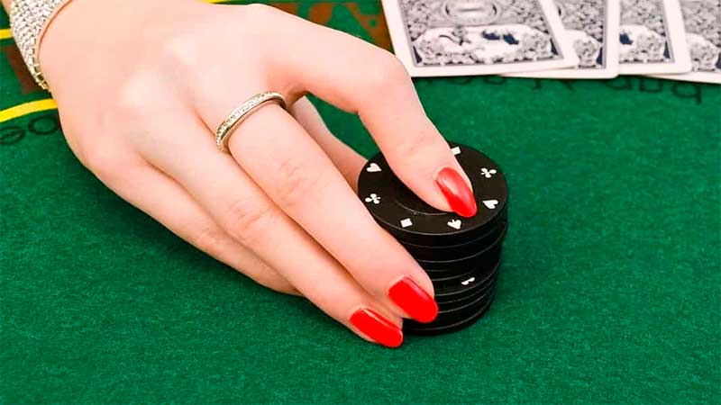 Woman's hand on casino chips